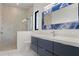Bathroom with dual sinks and a glass-enclosed shower with nice fixtures at 245 Lido Dr, Punta Gorda, FL 33950