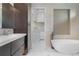 Luxurious bathroom boasts a modern soaking tub and stylish tile work, with an adjacent closet/storage area at 245 Lido Dr, Punta Gorda, FL 33950