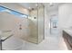 Sleek bathroom with a glass-enclosed shower, marble flooring, and modern fixtures at 245 Lido Dr, Punta Gorda, FL 33950