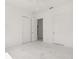 Bright bedroom features double doors and closet doors with white marble floors and white walls at 245 Lido Dr, Punta Gorda, FL 33950