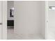 A view into the bedroom with white walls and a white marble floor from an open door at 245 Lido Dr, Punta Gorda, FL 33950