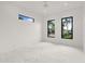 Bright, empty bedroom with marble floors and modern windows showing palm tree views at 245 Lido Dr, Punta Gorda, FL 33950