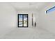 Bright bedroom with a ceiling fan, black glass doors and a small window at 245 Lido Dr, Punta Gorda, FL 33950