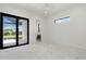 Bright bedroom with ceiling fan, black sliding glass door, and a small window at 245 Lido Dr, Punta Gorda, FL 33950