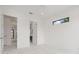 Bright bedroom with a white marble floor, a small window, and white walls at 245 Lido Dr, Punta Gorda, FL 33950