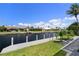 Gorgeous view of the wide canal lined with neatly kept homes and tropical landscaping at 245 Lido Dr, Punta Gorda, FL 33950