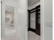 Walk-in closet features custom shelving and a glimpse into a modern bathroom at 245 Lido Dr, Punta Gorda, FL 33950