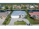 Gorgeous aerial view of the home, driveway, metal roof, lush landscaping, and three-car garage at 245 Lido Dr, Punta Gorda, FL 33950