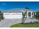 Beautiful exterior view of this property showcasing its modern design, two-car garage, and landscaping at 245 Lido Dr, Punta Gorda, FL 33950