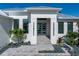 An inviting front entrance with a well-manicured walkway and modern door, exuding elegance at 245 Lido Dr, Punta Gorda, FL 33950