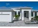 Close up of the exterior of this property showcasing its modern design, walkway, and landscaping at 245 Lido Dr, Punta Gorda, FL 33950