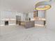 A chef's kitchen with modern design elements, expansive counter space, and marble floors at 245 Lido Dr, Punta Gorda, FL 33950