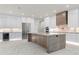 Stunning kitchen features white cabinetry, a large island, and modern stainless-steel appliances at 245 Lido Dr, Punta Gorda, FL 33950