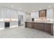 The modern kitchen boasts sleek white cabinetry, a center island, and premium stainless steel appliances at 245 Lido Dr, Punta Gorda, FL 33950