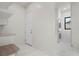 Clean laundry room with white cabinets, marble floors, and stacked washer and dryer at 245 Lido Dr, Punta Gorda, FL 33950
