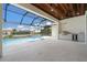 Outdoor kitchen with stainless grill, mini fridge, and access to the pool at 245 Lido Dr, Punta Gorda, FL 33950