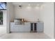 Outdoor kitchen has a built-in grill, sink, and beverage fridge beneath a granite countertop at 245 Lido Dr, Punta Gorda, FL 33950