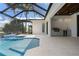 Screened-in pool area features a tanning ledge and an outdoor kitchen with a stainless steel grill at 245 Lido Dr, Punta Gorda, FL 33950