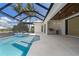 Screened-in pool area includes a tanning ledge and an outdoor kitchen with stainless steel grill at 245 Lido Dr, Punta Gorda, FL 33950