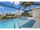 This sparkling screened-in pool and tanning ledge offer a beautiful view of the canal at 245 Lido Dr, Punta Gorda, FL 33950