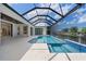 A stunning screened-in pool with a spa is surrounded by a spacious patio and offers waterfront views at 245 Lido Dr, Punta Gorda, FL 33950