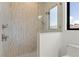 Modern shower features glass door, tan tile, and sleek shower fixtures at 245 Lido Dr, Punta Gorda, FL 33950