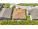 A bird's eye view of a well kept home with a patio and manicured backyard lawn at 24504 Buckingham Way, Punta Gorda, FL 33980