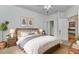 Inviting bedroom with warm lighting, decorative wall art, and a comfortable bed with stylish bedding at 24504 Buckingham Way, Punta Gorda, FL 33980