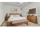 Comfortable bedroom with decorative art, warm lighting, a decorative bench and hardwood flooring at 24504 Buckingham Way, Punta Gorda, FL 33980