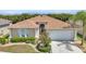 Charming home with lush landscaping, a well-maintained lawn, and a welcoming two-car garage at 24504 Buckingham Way, Punta Gorda, FL 33980