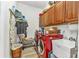 Efficient laundry room featuring a sink, upper cabinets, and red washer and dryer at 24504 Buckingham Way, Punta Gorda, FL 33980