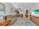 Comfortable living room boasts a plush recliner and seamless flow into the eat-in kitchen area with bar seating at 24504 Buckingham Way, Punta Gorda, FL 33980