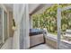 Relaxing covered spa area with privacy curtains and a view of lush greenery at 24504 Buckingham Way, Punta Gorda, FL 33980