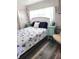 Comfortable bedroom with a bed, side tables, and coastal themed decor at 326 Trailorama Dr, North Port, FL 34287