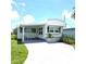 Charming single-story home with a covered porch and well-maintained landscaping at 326 Trailorama Dr, North Port, FL 34287
