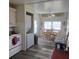 View of the kitchen leading into a dining area with a charming round table at 326 Trailorama Dr, North Port, FL 34287