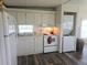 Functional kitchen featuring a refrigerator, stove, and convenient washer/dryer combo at 326 Trailorama Dr, North Port, FL 34287