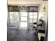 Enclosed patio with comfortable seating and decorative coastal accents at 326 Trailorama Dr, North Port, FL 34287