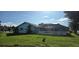 The backyard includes a screened lanai, lush landscaping, and a well-maintained lawn at 39 Norman St, Port Charlotte, FL 33954
