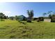 Backyard view featuring a shed, greenery, and clear skies at 39 Norman St, Port Charlotte, FL 33954