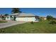 Charming, light blue single-story home with manicured lawn and two-car garage at 39 Norman St, Port Charlotte, FL 33954