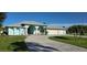 Charming, light blue single-story home with manicured lawn and paver driveway for curb appeal at 39 Norman St, Port Charlotte, FL 33954