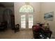 Open, airy foyer with natural light, adjacent to dining room, offers space and storage at 39 Norman St, Port Charlotte, FL 33954