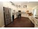 Large kitchen area featuring wood-look flooring, stainless steel appliances, and decorative lighting at 39 Norman St, Port Charlotte, FL 33954