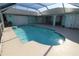 The pool area features a large in-ground pool with ample deck space and a screen enclosure at 39 Norman St, Port Charlotte, FL 33954
