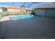 View of a private screened-in pool with a sun deck and lush backyard surroundings at 39 Norman St, Port Charlotte, FL 33954