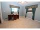Office room featuring tile floors, light blue walls, and a ceiling fan at 39 Norman St, Port Charlotte, FL 33954
