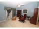 Living room featuring tile floors, light blue walls, and a red chair at 39 Norman St, Port Charlotte, FL 33954