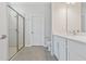 Modern bathroom featuring a glass shower, gray tile flooring, and white vanity with a bright, neutral color palette at 4627 Schoen St, North Port, FL 34291