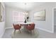 Cozy dining room with modern chandelier and decor that complements the color palette at 4627 Schoen St, North Port, FL 34291